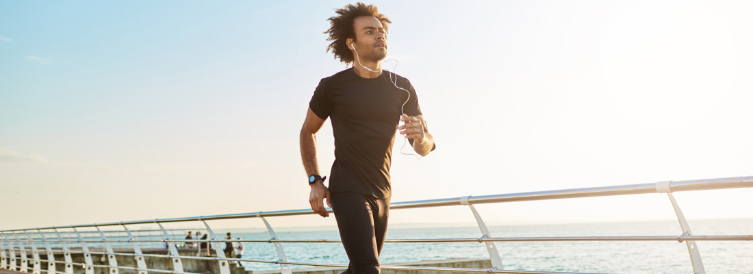 Man running outdoors, symbolizing fitness without a gym.